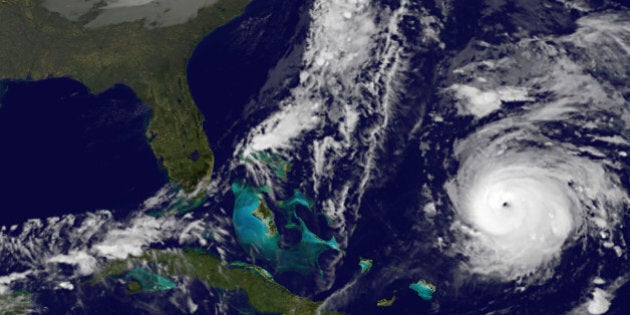 This image provided by NOAA Thursday Oct. 16, 2014 shows Hurricane Gonzalo, lower right. At 2 a.m. EDT Thursday the storm had top sustained winds near 125 mph (205 kph) and was centered about 555 miles (1,075 kilometers) south south-west of Bermuda early Thursday, the U.S. National Hurricane Center said. It was moving north at 9 mph (20 kph). (AP Photo/NOAA)