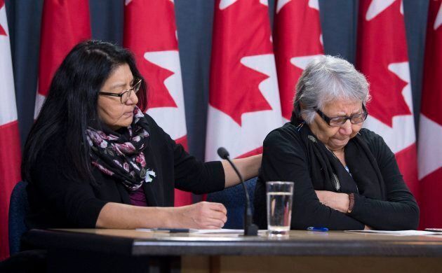 Deputy Grand Chief Anna Betty Achneepineskum comforts Angela Shisheesh as she speaks during a news conference in Ottawa on Jan. 15, 2018.