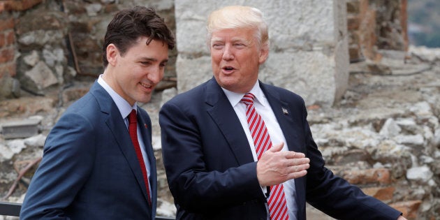 Canadian Prime Minister Justin Trudeau (L) and U.S. President Donald Trump talk as they arrive for a family photo, during the G7 Summit in Taormina, Sicily, Italy, May 26, 2017.