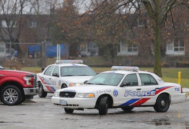 Police officers leave the junior public school near the site of a reported attack on a girl wearing a hijab in Toronto, Ont., on Jan. 12, 2018.