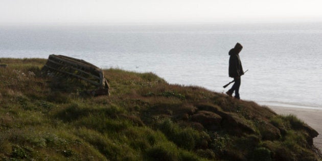 WAINWRIGHT, AK - JULY 18: A teenager explores the shoreline near the Chukchi Sea in Wainwright, Alaska on July 18, 2011. (Photo by Bonnie Jo Mount/The Washington Post via Getty Images)