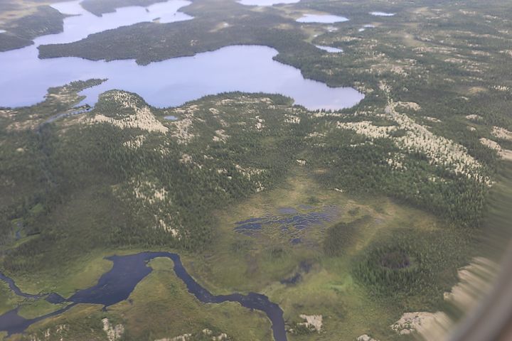An aerial view of the landscape surrounding the community of Chisasibi, illustrating the vast expanses of open spruce and lichen forests, wetlands and waterways of Eeyou Istchee. (Photo by NCC)