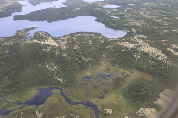 An aerial view of the landscape surrounding the community of Chisasibi, illustrating the vast expanses of open spruce and lichen forests, wetlands and waterways of Eeyou Istchee. (Photo by NCC)