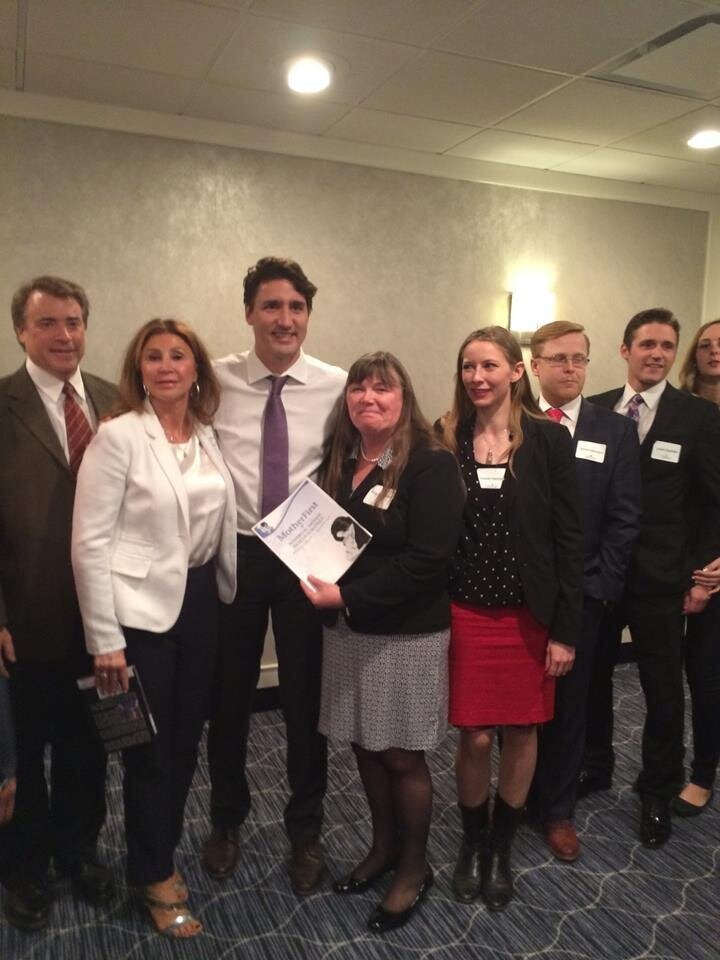 Dr. Angela Bowen gives Prime Minister Justin Trudeau the "Mother First" report on April 27, 2016 in Saskatoon.