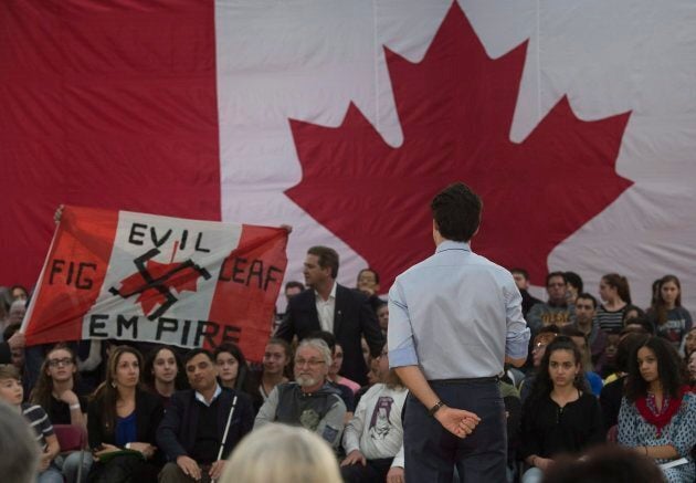 A heckler screams at Prime Minister Justin Trudeau during a town hall meeting on Jan. 18, 2018 in Quebec City.