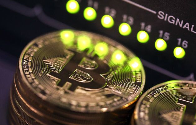 tacks of bitcoins sit near green lights on a data cable terminal inside a communications room at an office in this arranged photograph in London, U.K., on Tuesday, Sept. 5, 2017.