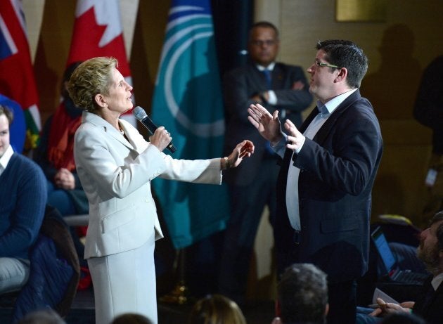 Will Hickie, a member of the public in attendance, asks a question as he interrupts Ontario Premier Kathleen Wynne as she speaks during a town hall meeting in Ottawa on Jan. 18, 2018.