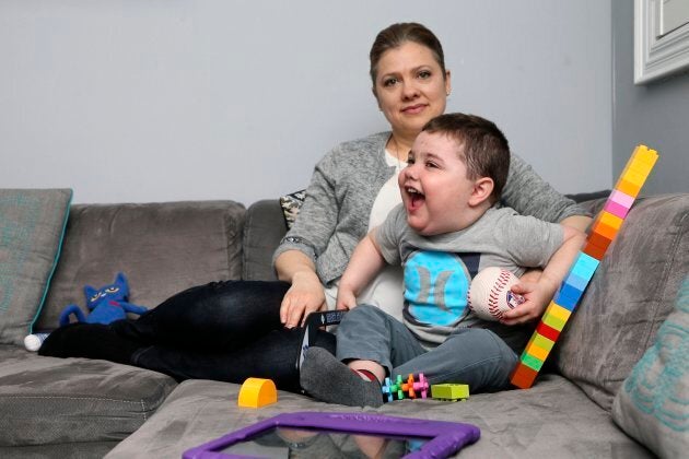 Janet Asher and son Benjamin pose at the family's home on Mar. 31, 2016. Benjamin has been on a waiting list for two years to receive provincially-funded Autism therapy.