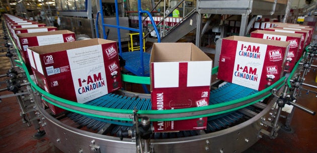 Empty cardboard cases make their way down a conveyor where they will be packaged with beer.