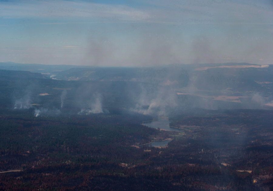 Smoke from wildfires fills the air and burned trees are seen in this aerial view from a Canadian Forces Chinook helicopter near Williams Lake, B.C., on July 31, 2017.
