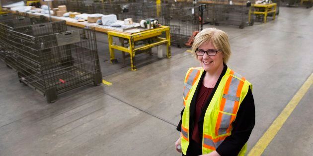 Public Services Minister Carla Qualtrough walks through the mail room at the Canada Post Gateway location in Mississauga, Ont., on Jan. 24, 2018.