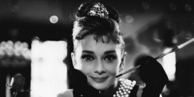 1961: Audrey Hepburn (1929 - 1993) wields a cigarette holder in her role as the charming gold-digger Holly Golightly in 'Breakfast at Tiffany's', directed by Blake Edwards. (Photo via John Kobal Foundation/Getty Images)