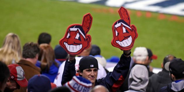 A fan holds up two Chief Wahoo heads during Game 1 of the 2016 World Series between Chicago and Cleveland at Progressive Field on Oct. 25, 2016 in Cleveland, Ohio.