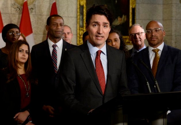 Prime Minister Justin Trudeau speaks with media during an availability in the foyer with his caucus on Parliament Hill, in Ottawa on Jan. 30, 2018.