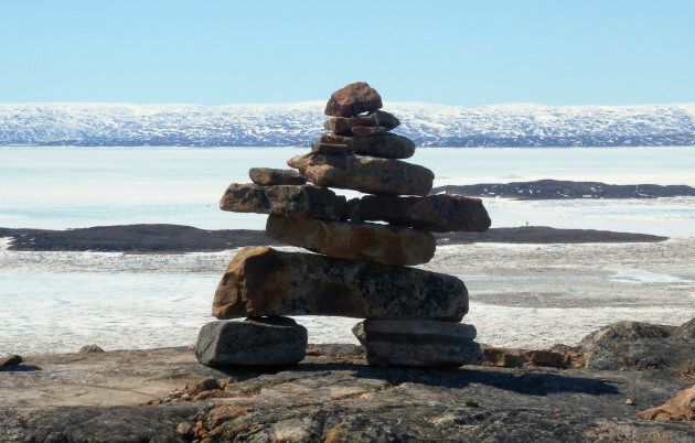 A traditional Inuit inukshuk stone formation looks out over Frobisher Bay near Iqaluit, on June 14, 2011.
