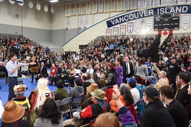 Prime Minister Justin Trudeau, left, argues with a protester at a public town hall in Nanaimo, B.C., on Feb. 2, 2018.