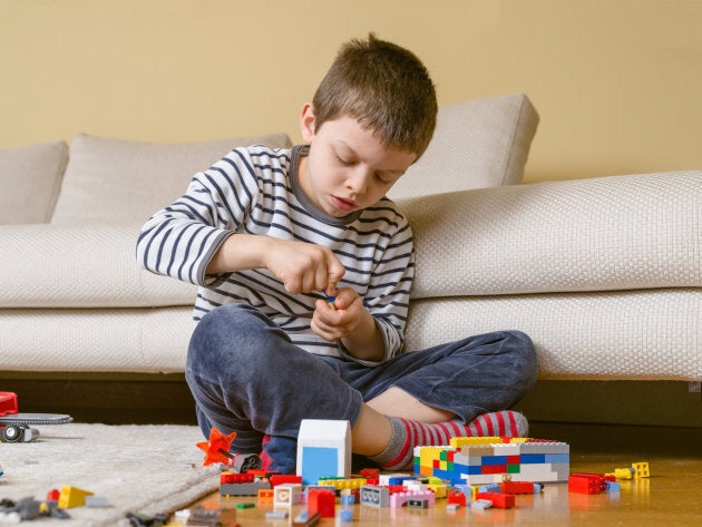 Kid playing best sale with legos