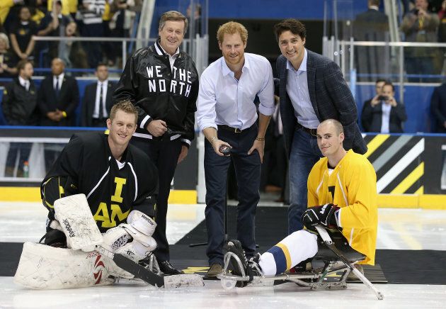 Britain's Prince Harry, left, drops the puck in as Justin Trudeau, right, ahead of the sledge-hockey event during the Invictus Games in Toronto on May 2, 2016.