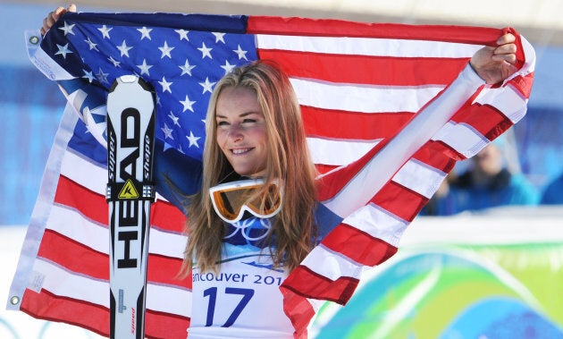 U.S. bronze medallist Lindsey Vonn celebrates with her national flag on the podium during the Vancouver 2010 Winter Olympics.