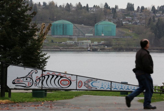 A man walks in Cate's Park, on lands of the Tseil-Waututh Nation across Burrard Inlet from Kinder Morgan's Westridge Terminal, in North Vancouver, B.C. on Nov. 18, 2016.