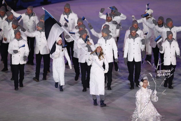 Flag bearer Saskia Alusalu of Estonia leads the team.