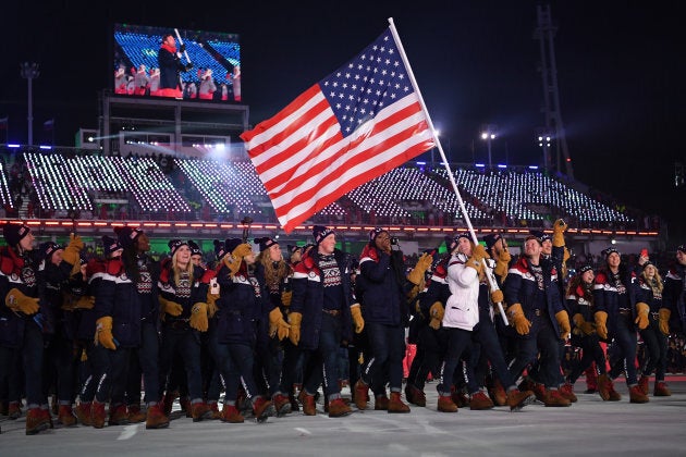 Flag-bearer Erin Hamlin of the United States leads the team during the opening ceremony.