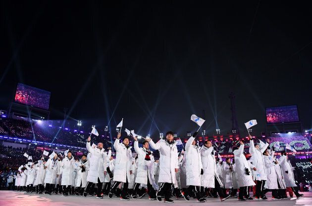 The North Korea and South Korea Olympic teams enter together under the Korean Unification Flag during the Parade of Athletes.