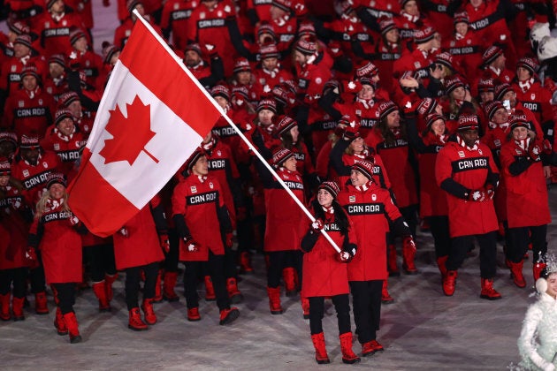 Flag bearers Tessa Virtue and Scott Moir leads Team Canada during the opening ceremony.