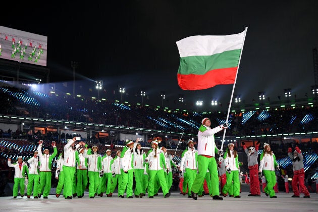 Flag bearer Radoslav Yankov of Bulgaria and teammates enter the stadium during the opening ceremony.