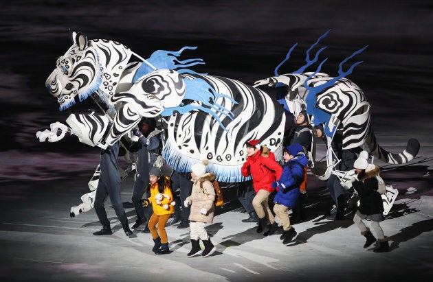 Children are led by a white tiger at the opening ceremony of the PyeongChang 2018 Winter Olympic Games.