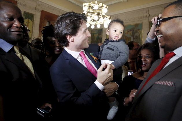 Prime Minister Justin Trudeau holds a baby during an event to mark the 20th Anniversary of Black History Month on Parliament Hill in Ottawa, on Feb. 24, 2016.