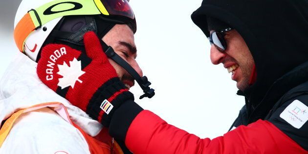 Canada's Philippe Marquis (L) hugs a team member after competing in the Freestyle Skiing Men's Moguls Qualification event at Phoenix Snow Park during the Pyeongchang Winter Olympics in South Korea on Feb. 9, 2018.