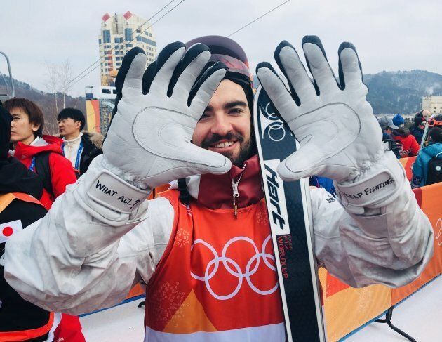 Canada's Philippe Marquis shows off the motivational messages he wrote on his gloves at the 2018 Winter Olympics.