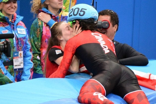 Canada's Charles Hamelin kisses his girlfriend Marianne St-Gelais after winning the gold medal in the Men's Short Track during the Sochi Winter Olympics on Feb. 10, 2014.