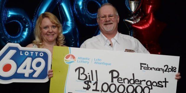 Carrie and Bill Pendergast pose with their novelty cheque after Bill won $1 million in a Lotto 6/49 draw.