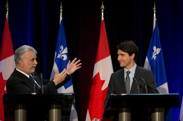 Canadian Prime Minister Justin Trudeau and Quebec Premier Philippe Couillard sign an infrastructure agreement in Montreal on Dec. 16, 2016.