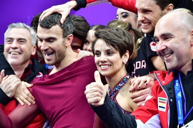 Canada's Meagan Duhamel, centre right and partner Eric Radford, centre left, celebrate with their teammates during the figure skating team event at the PyeongChang Olympics.