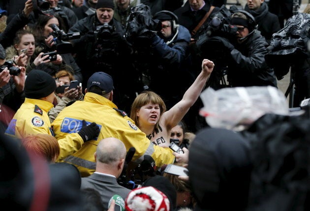 A protester is detained by police after an Ontario judge found Jian Ghomeshi not guilty of five criminal charges in Toronto on March 24, 2016.