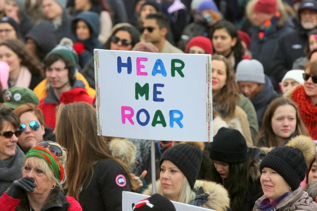 A demonstrator holds a sign saying 'Hear Me Roar' as hundreds take part in the Women's March in downtown Toronto on Jan. 20, 2018.