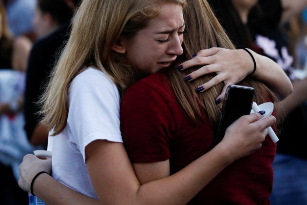 Students mourn during a candlelight vigil for victims the shooting at nearby Marjory Stoneman Douglas High School, in Parkland, Florida, on Feb. 15, 2018.