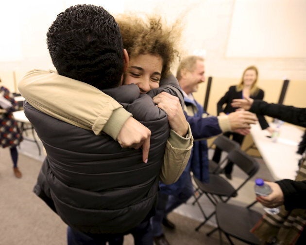 Anas Francis is reunited with his cousin Syrian refugee Laila Beylouneh, 13, at the Welcome Centre in Montreal, Que., on Dec. 12, 2015.