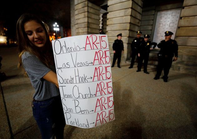 A student holds a sign noting the use of the AR-15 automatic rifle in multiple mass killings, after a demonstration calling for safer gun laws outside the North Carolina State Capitol building six days after the shooting at Marjory Stoneman Douglas High School, in Raleigh, North Carolina, on Feb 20, 2018.