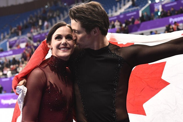 Canada's Tessa Virtue and Canada's Scott Moir celebrate after the ice dance event.