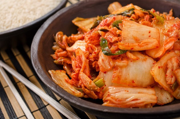 A bowl of traditional Korean napa kimchi with white rice.