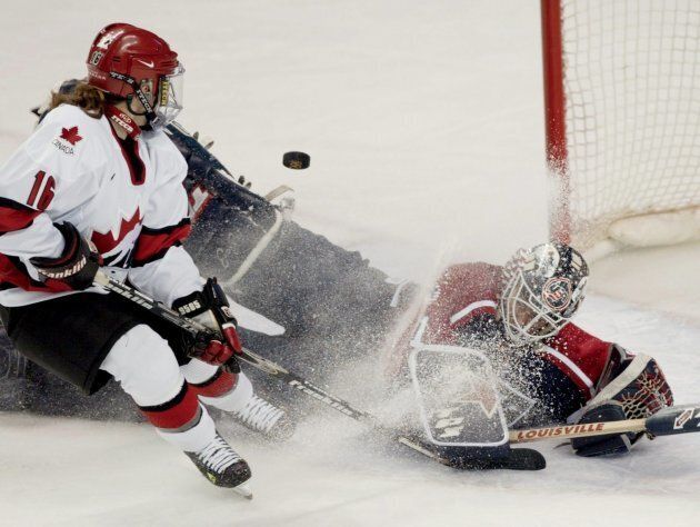 Canada's Jayna Hefford scores the team's third goal over United States goaltender Sara Decosta in the gold medal game at the 2002 Olympic Games.