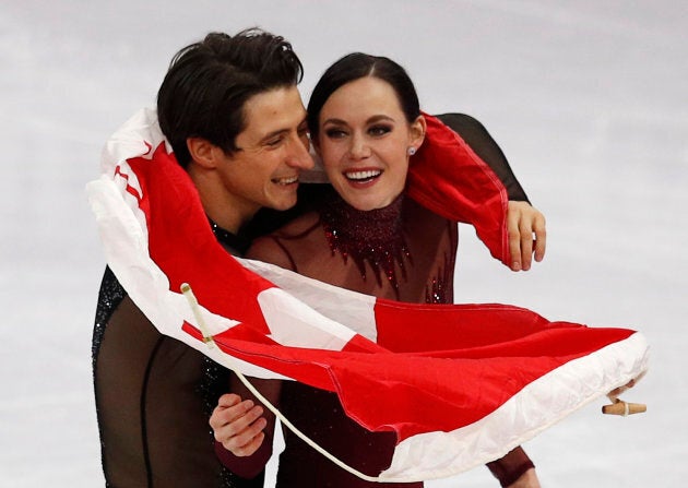 Gold medallists Tessa Virtue and Scott Moir leave the ice after the ice dance competition at the Pyeongchang 2018 Winter Olympics, Feb. 20, 2018.