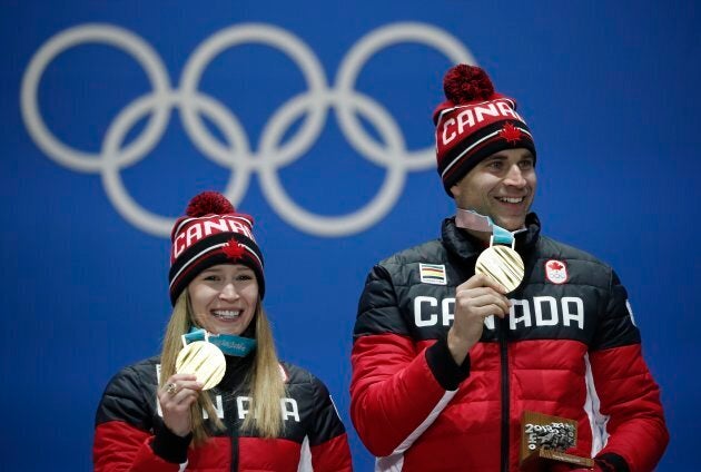 Kaitlyn Lawes and John Morris on the podium on Feb. 14, 2018 at the 2018 Winter Olympics.