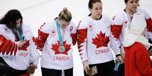 Canada's Jocelyne Larocque, second from right, holds her silver medal after losing to the U.S in the women's gold medal hockey game at the Winter Olympics in Gangneung, South Korea on Feb. 22, 2018.