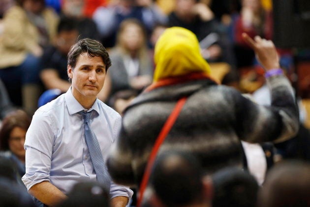 Prime Minister Justin Trudeau listens to a question about Child and Family Services at a town hall meeting at the University of Manitoba in Winnipeg on Jan. 31, 2018.