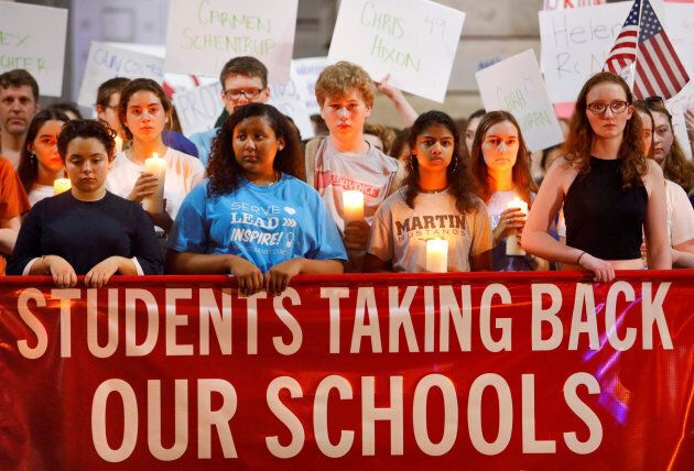 High school students observe a moment of silence in memory of the victims of the shooting at Marjory Stoneman Douglas High School, during a demonstration calling for safer gun laws outside the North Carolina State Capitol building in Raleigh, North Carolina, on Feb. 20, 2018.